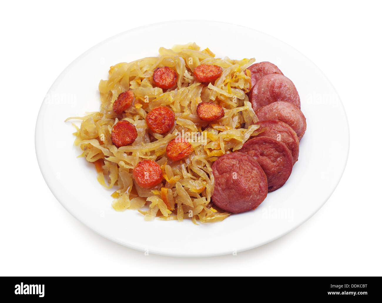 Braised cabbage with sausage in a plate on white Stock Photo