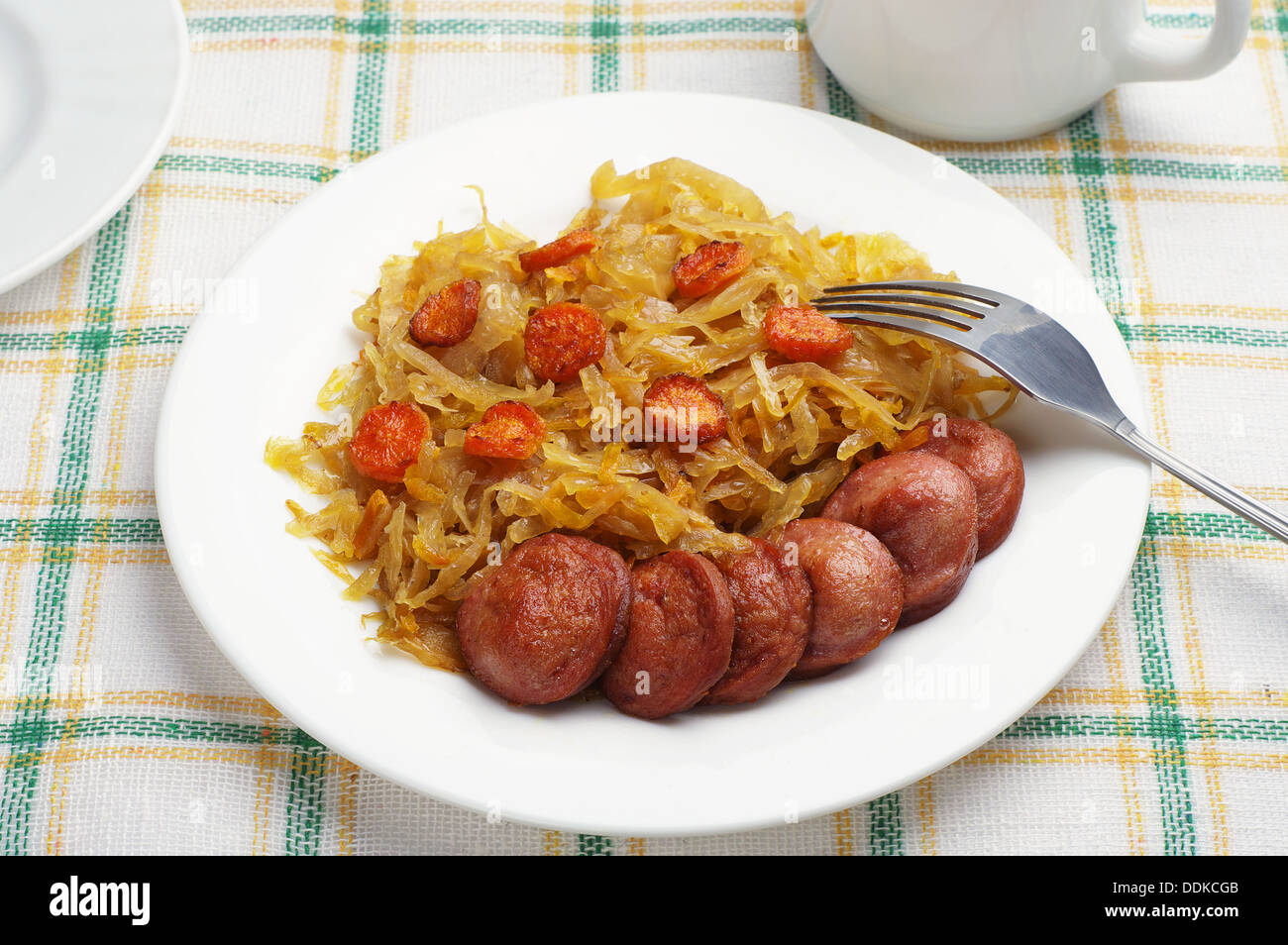 Grilled sausage with braised cabbage on a table Stock Photo