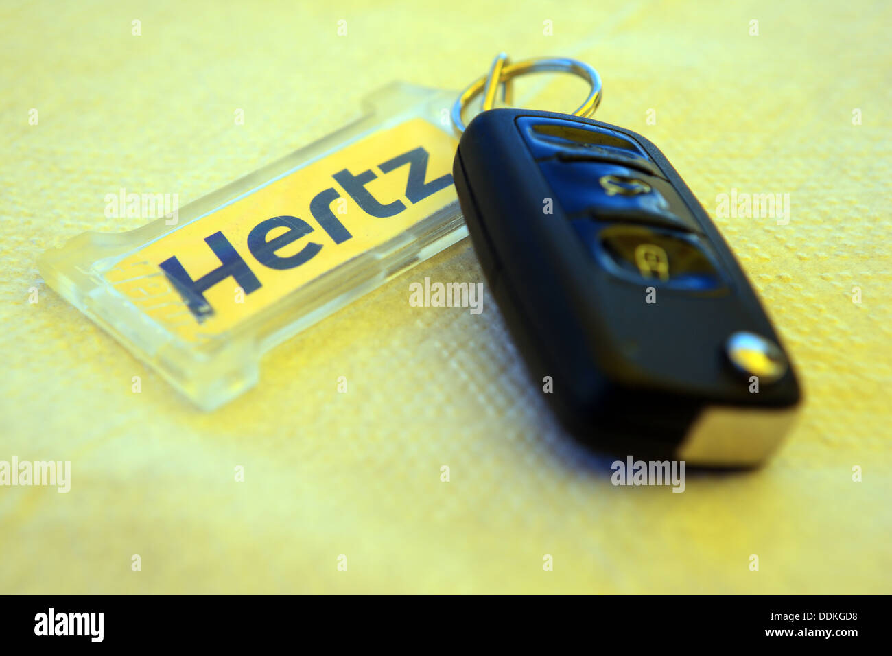 Set of Hertz hire car keys on a yellow background Stock Photo