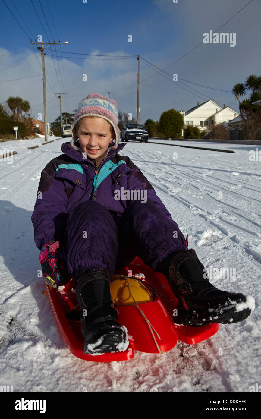 Young girl on snow sled, Dunedin, Otago, South Island, New Zealand