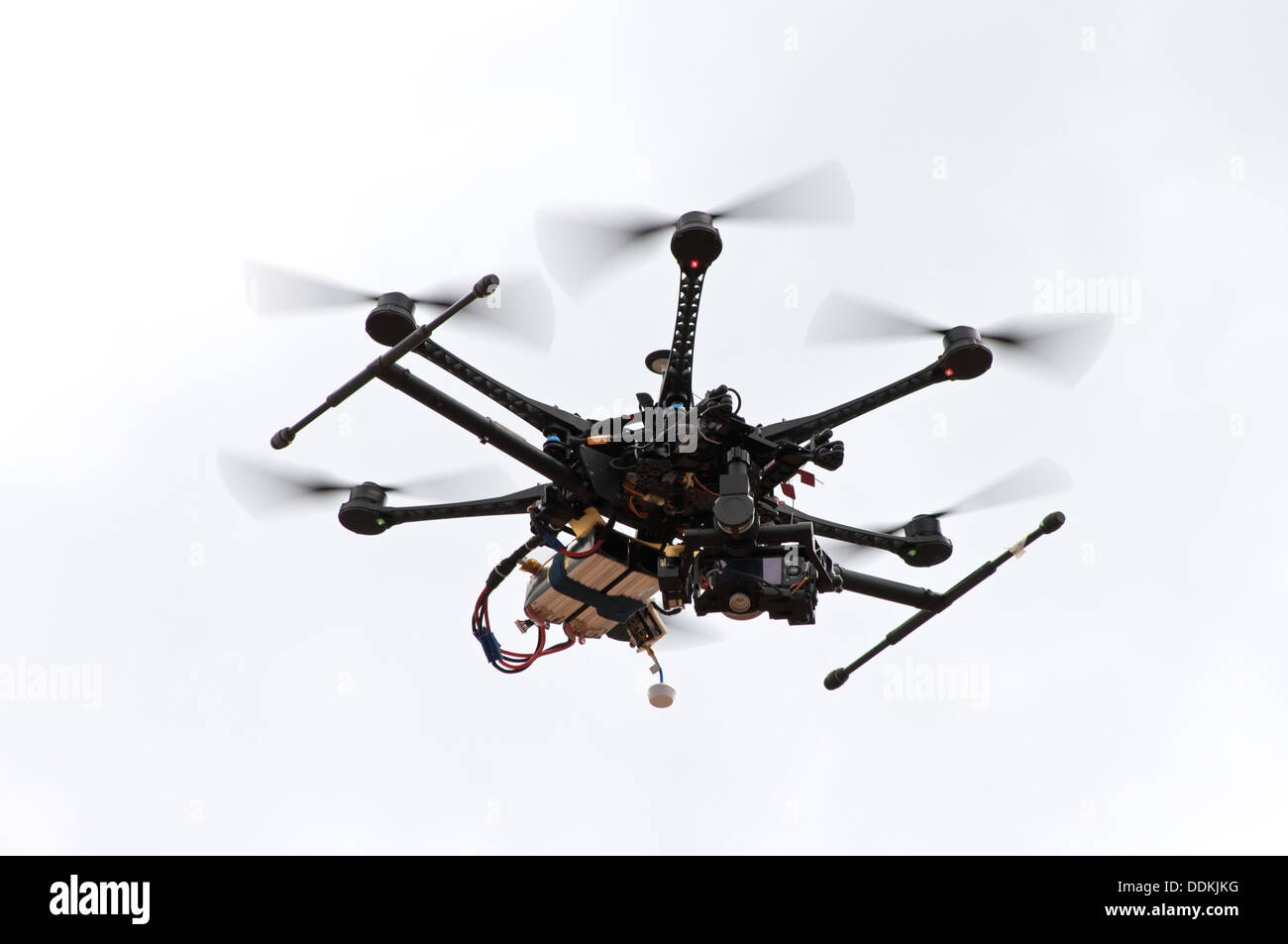 Remote control helicopter with camera flying in the sky Stock Photo