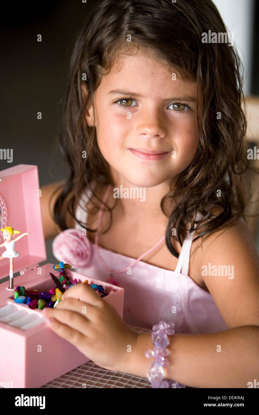 Little caucasian girl playing with a music box Stock Photo Alamy