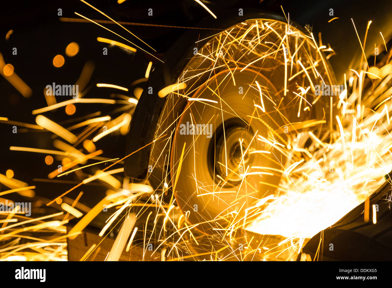 sharpening and cutting of iron by abrasive disk machine Stock Photo - Alamy