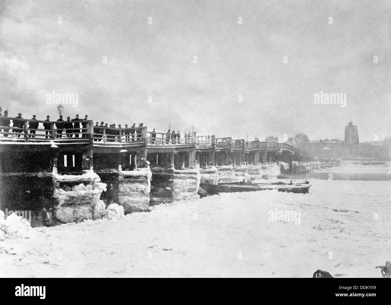 People looking at the frozen Thames from Old Putney Bridge looking South, Putney, London, c1881. Artist: Unknown Stock Photo