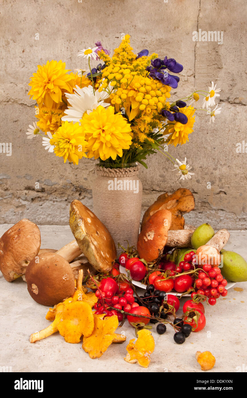 still life bouquet of yellow flowers and chamomiles with boletus edulis ...