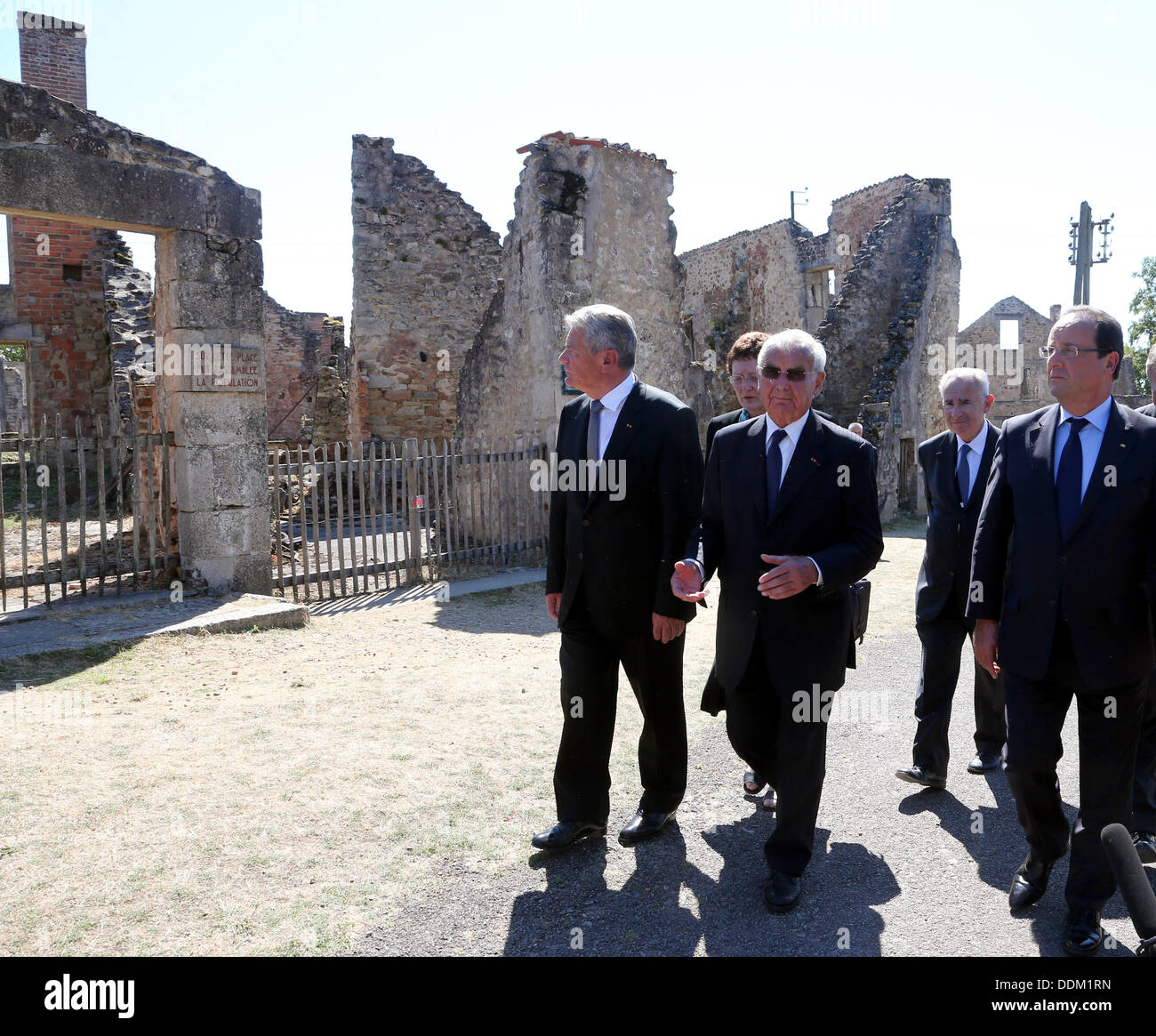 Oradour-sur-Glane, France. 04th Sep, 2013. German President Joachim Gauck (L), French President Francois Hollande and survivor of the massacre in Oradour-sur-Glane during World War II Robert Hebras (2-L) are pictured at the memorial site in Oradour-sur-Glane, France, 04 September 2013. A unit of SS officers murdered 642 citizens of the town in June 1944. The German President is on a three-day visit to France. Photo: WOLFGANG KUMM/dpa/Alamy Live News Stock Photo