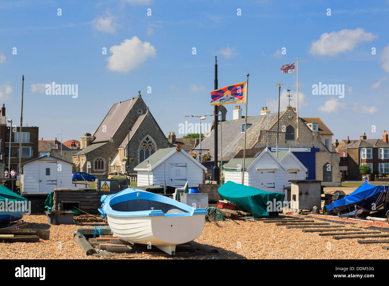 Boats and bathing huts on Walmer beach on south coast in Deal, Kent, England, UK, Britain Stock Photo