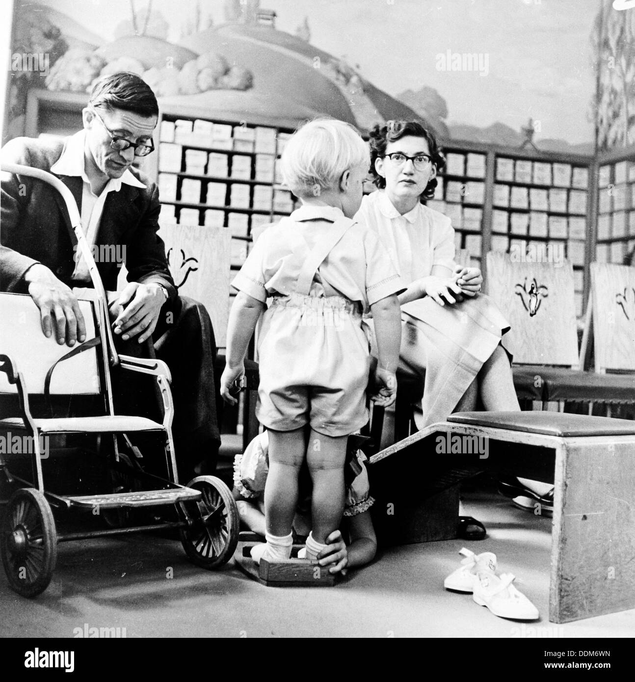 Child being fitted for new shoes in a London shoe shop, c1950s. Artist: Henry Grant Stock Photo
