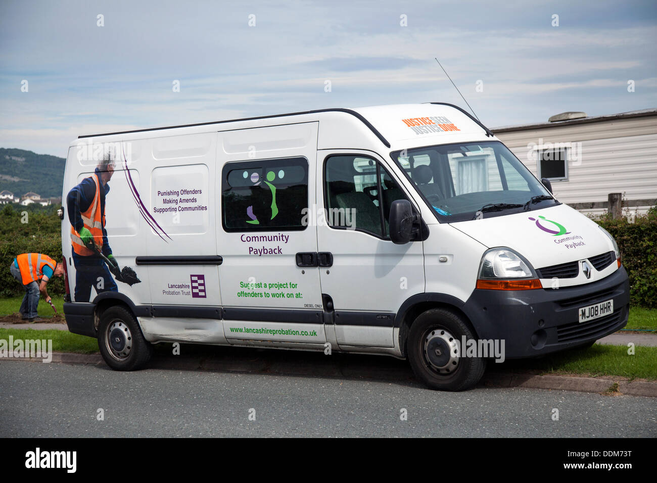 Community Payback sentence offenders 'Justice Seen Justice Done' van in Carnforth, UK September, 2012.  Lancashire probation trust Community Payback scheme; vehicle with workers doing Unpaid Work clearing roadside verges, bearing the phrases 'Punishing offenders making amends' Stock Photo