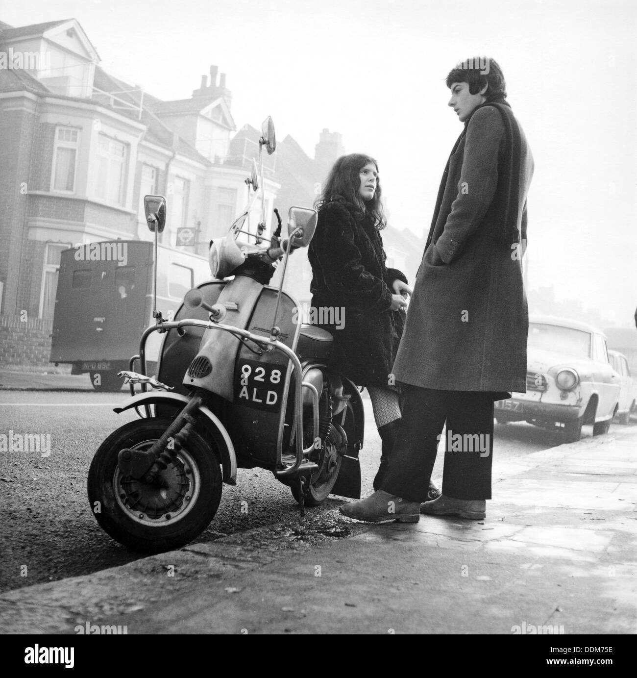 Couple with a scooter, London, 1967. Artist: Henry Grant Stock Photo