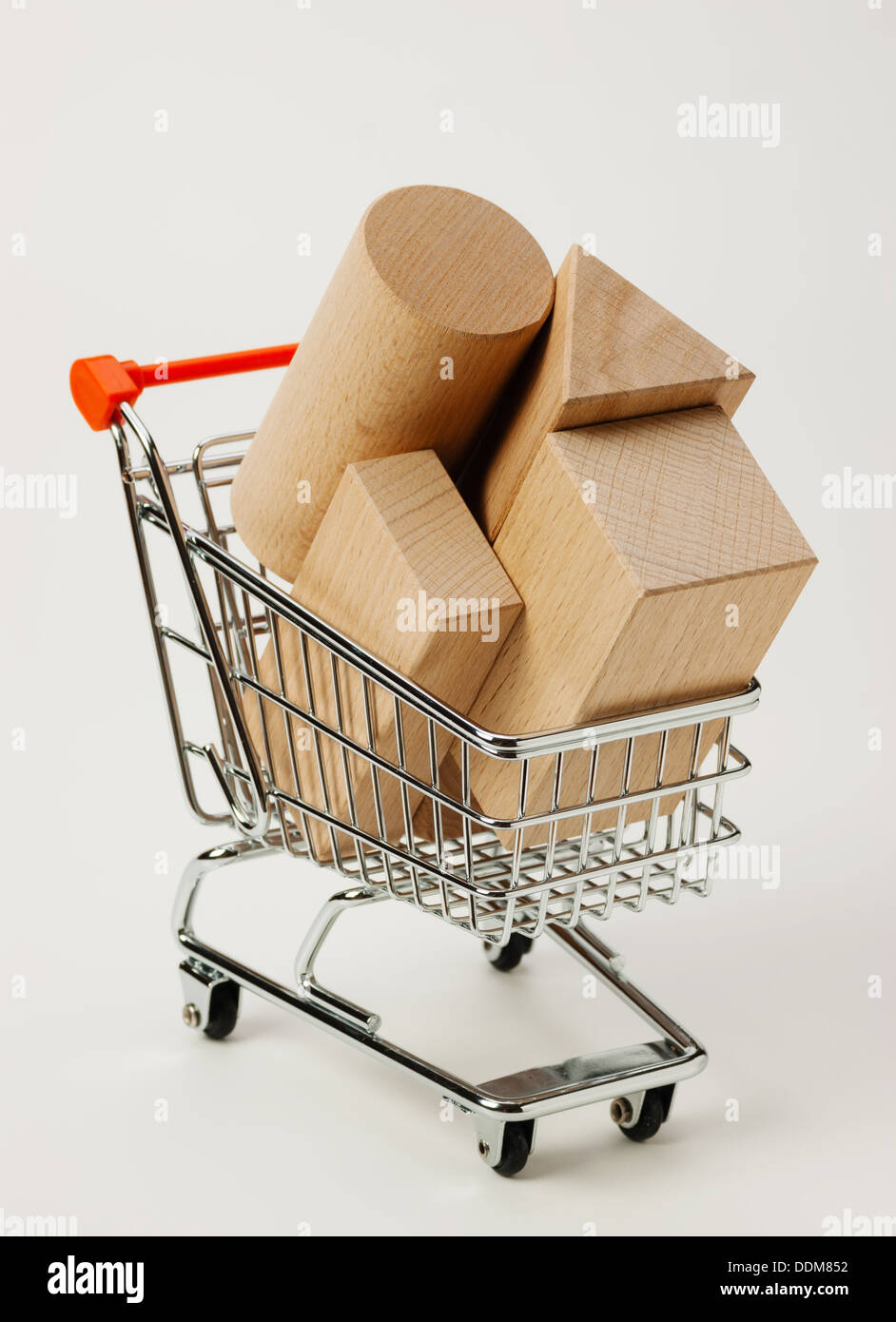 wooden blocks for the construction in shopping trolley on a white