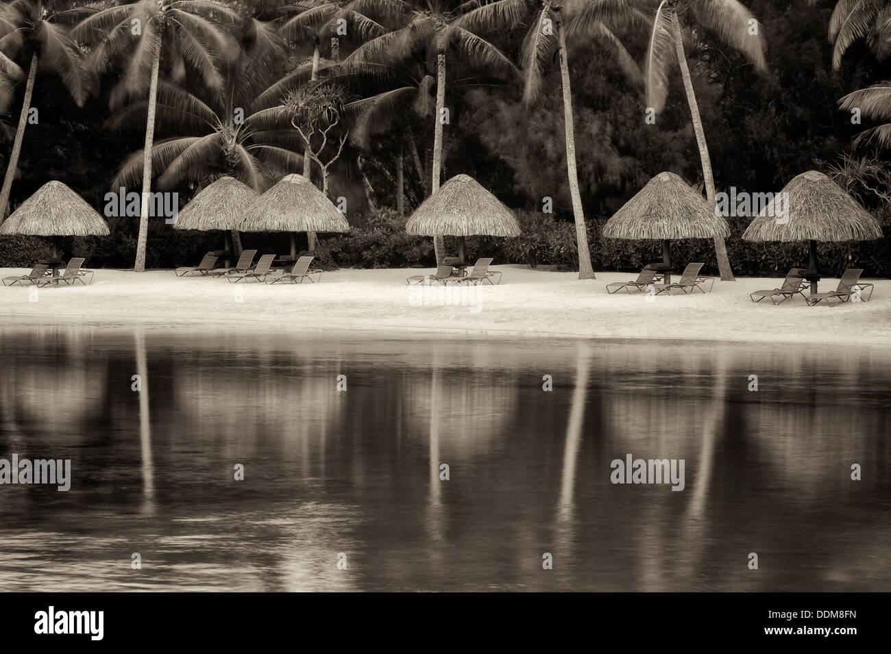 Beach on lagoon with umbrellas and chairs. Bora Bora. French Polynesia Stock Photo