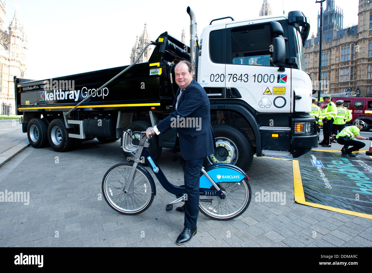 London, UK - 4 September 2013: the Transport Minister Stephen Hammond poses for a picture next to a Heavy Goods Vehicle (HGV) during the Metropolitan Police ‘Exchanging Places’ event, organised to raise awareness of the safety issues faced by lorry drivers and cyclists. Credit:  Piero Cruciatti/Alamy Live News Stock Photo