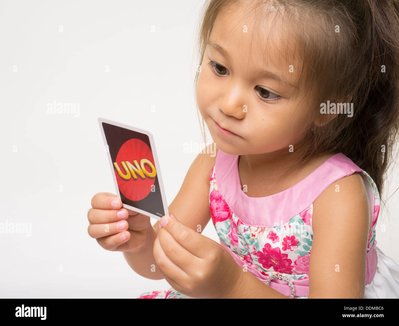 Uno Card Game by Mattel with young girl Stock Photo