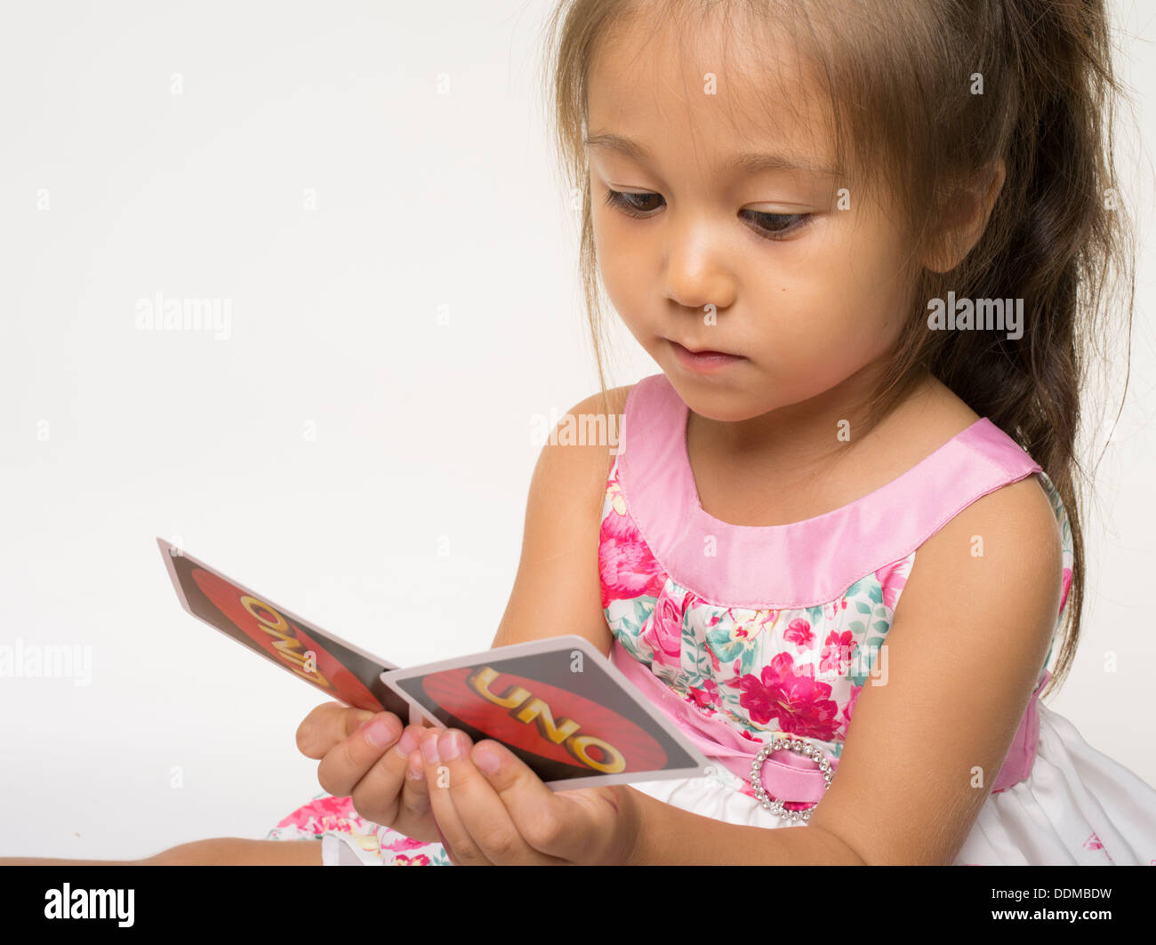 Uno Card Game by Mattel with young girl Stock Photo