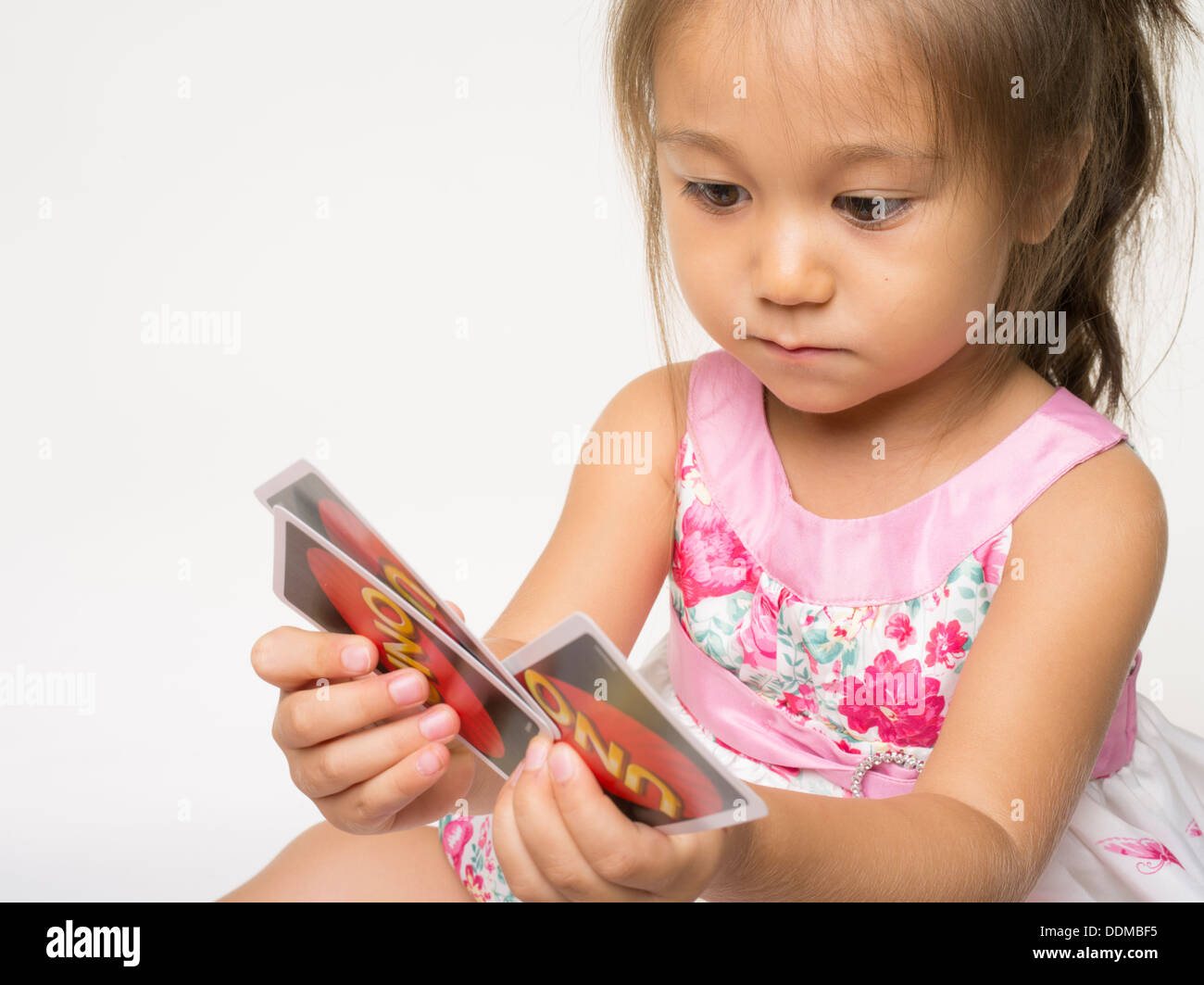 Uno Card Game by Mattel with young girl Stock Photo