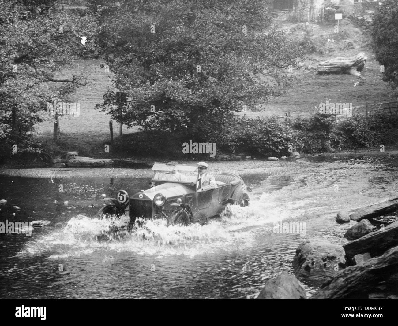 A Lancia Lambda being driven through water, c1925. Artist: Unknown Stock Photo