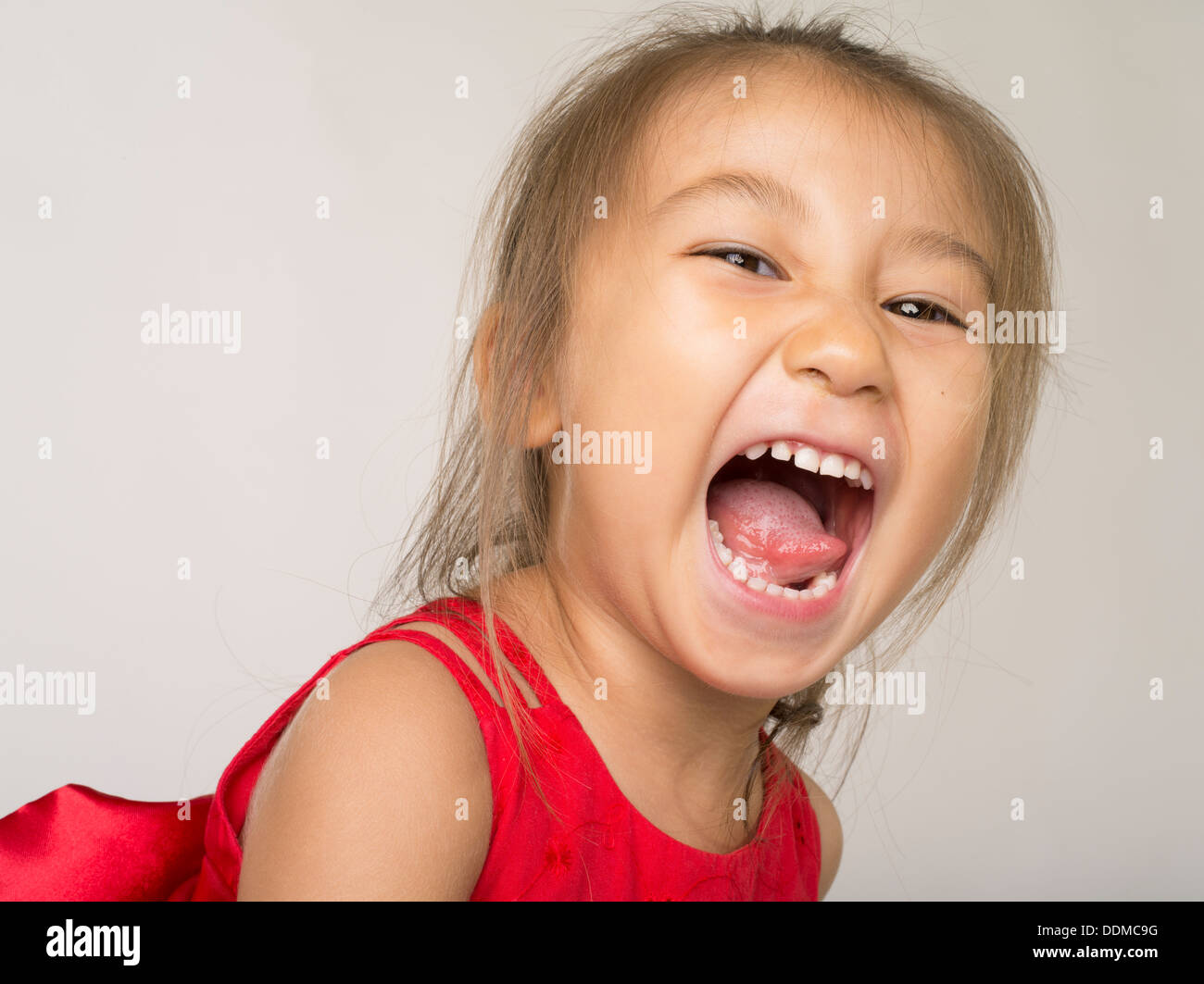 Young Asian girl laughing Stock Photo