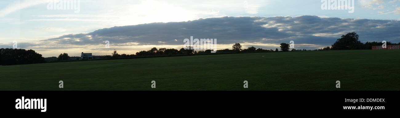 panorama cloud grass field trees blue country side Stock Photo