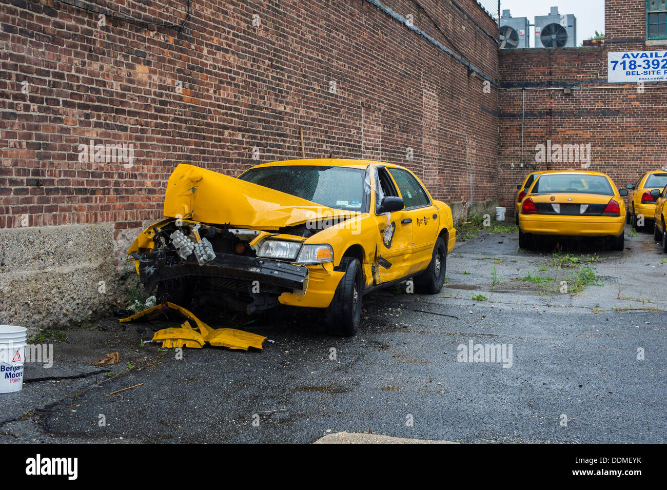 Accident damaged taxi in the lot of a garage in the Astoria