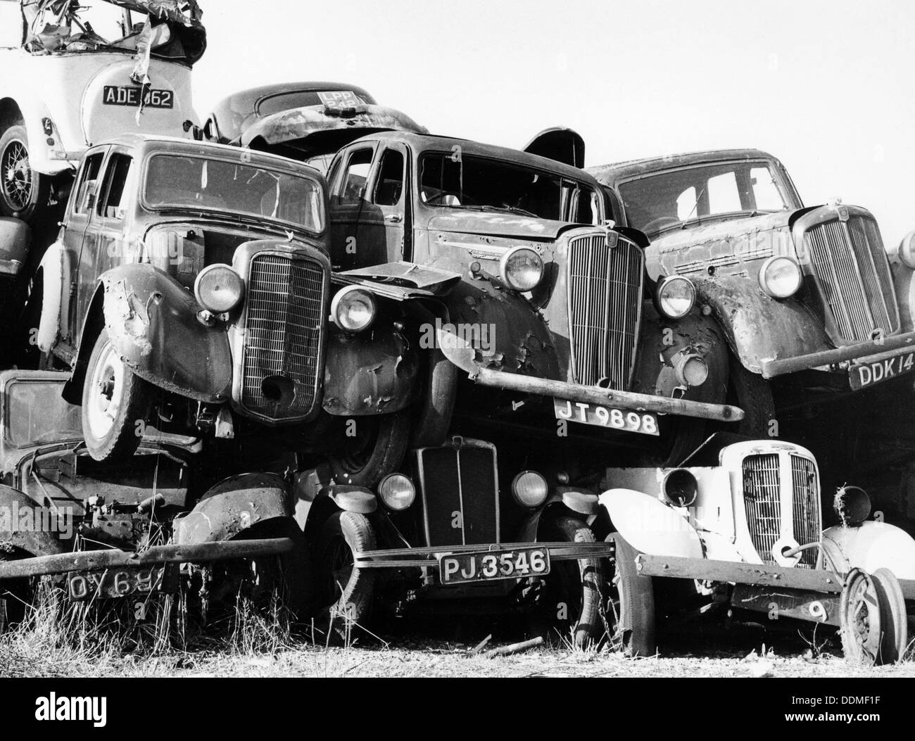 Old cars piled up in a scrapyard, Britain. Artist: Unknown Stock Photo