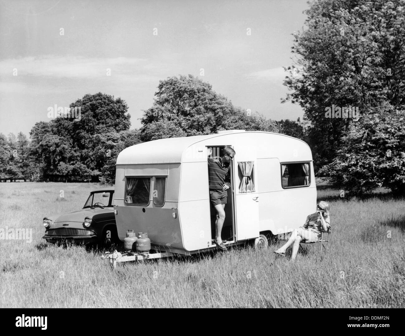 Couple on holiday with their 1963 Sprite Alpine caravan, (c1963?). Artist: Unknown Stock Photo
