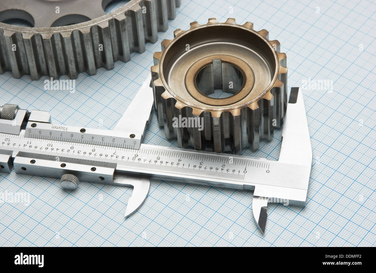 gears and caliper on graph paper Stock Photo Alamy