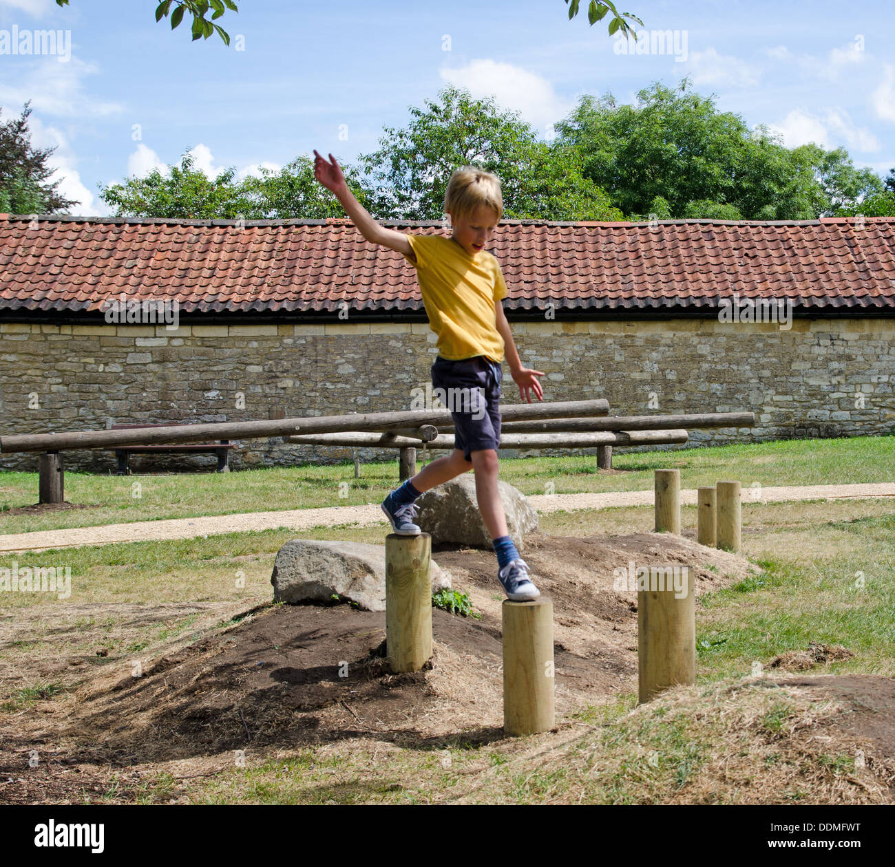 Young boy playing in a playground Stock Photo - Alamy