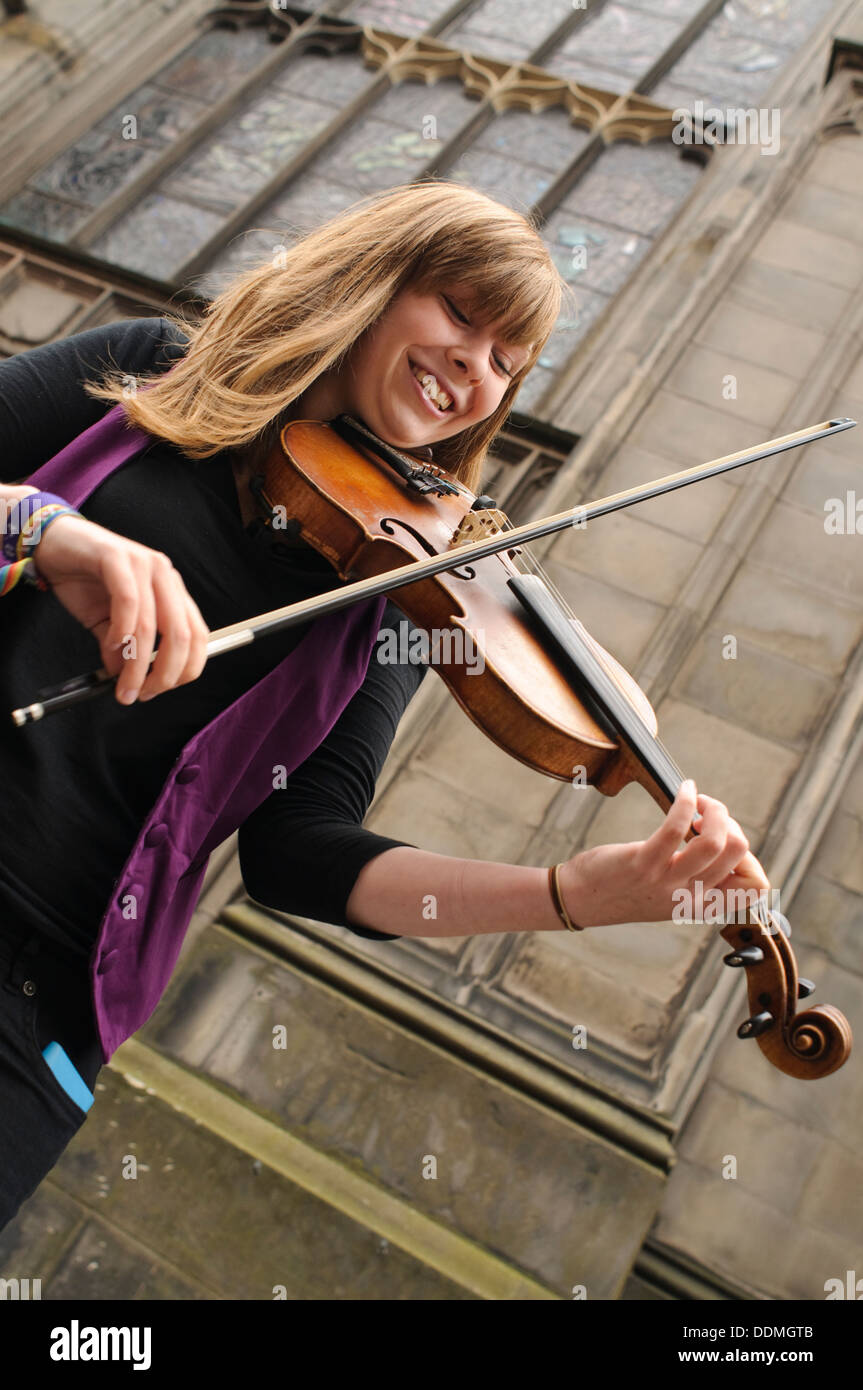 Female violinist performing on the Royal Mile during the Edinburgh Festival Fringe, Edinburgh, Scotland. Stock Photo