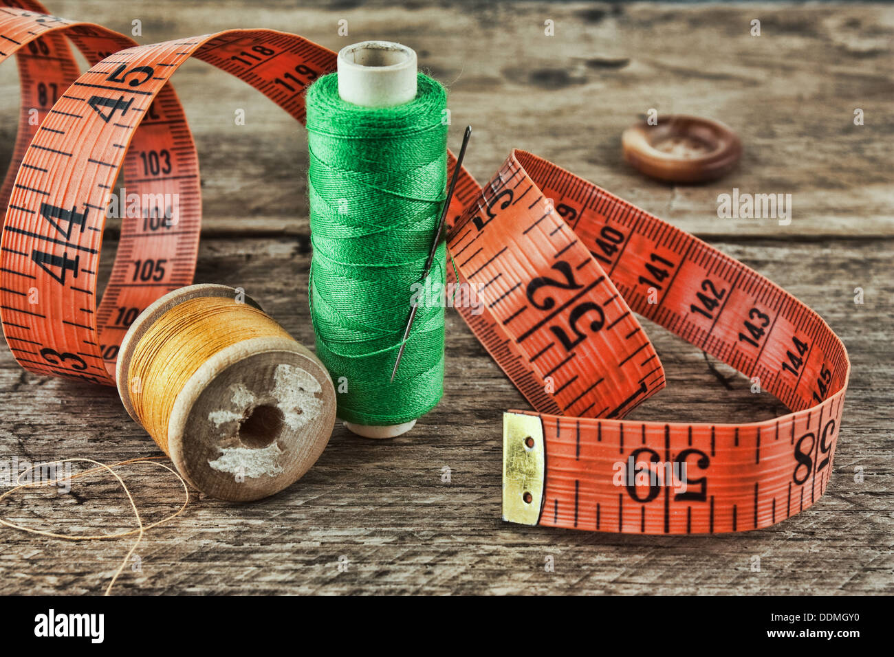 still life of spools of thread on a wooden background Stock Photo