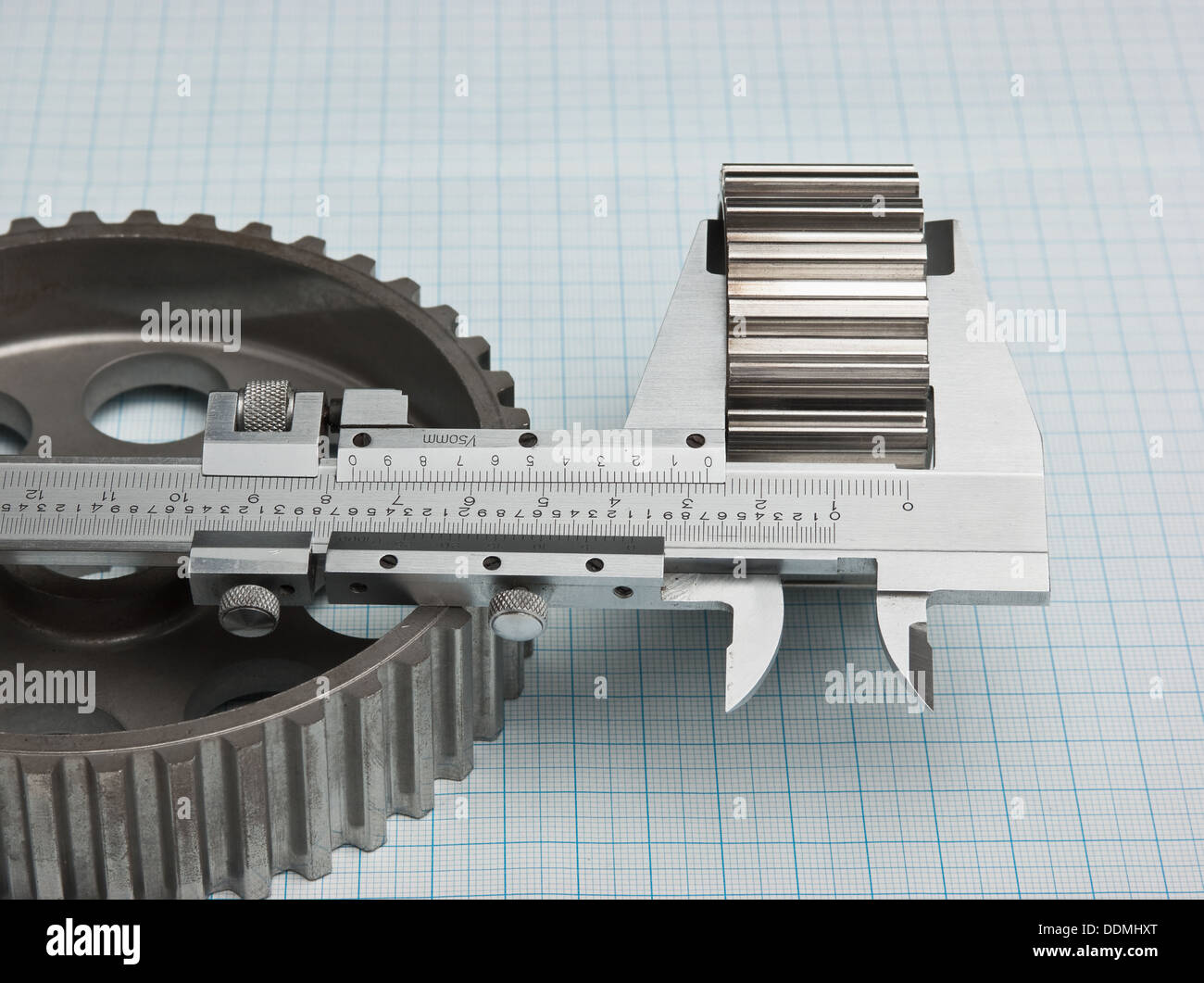 gears and caliper on graph paper Stock Photo Alamy