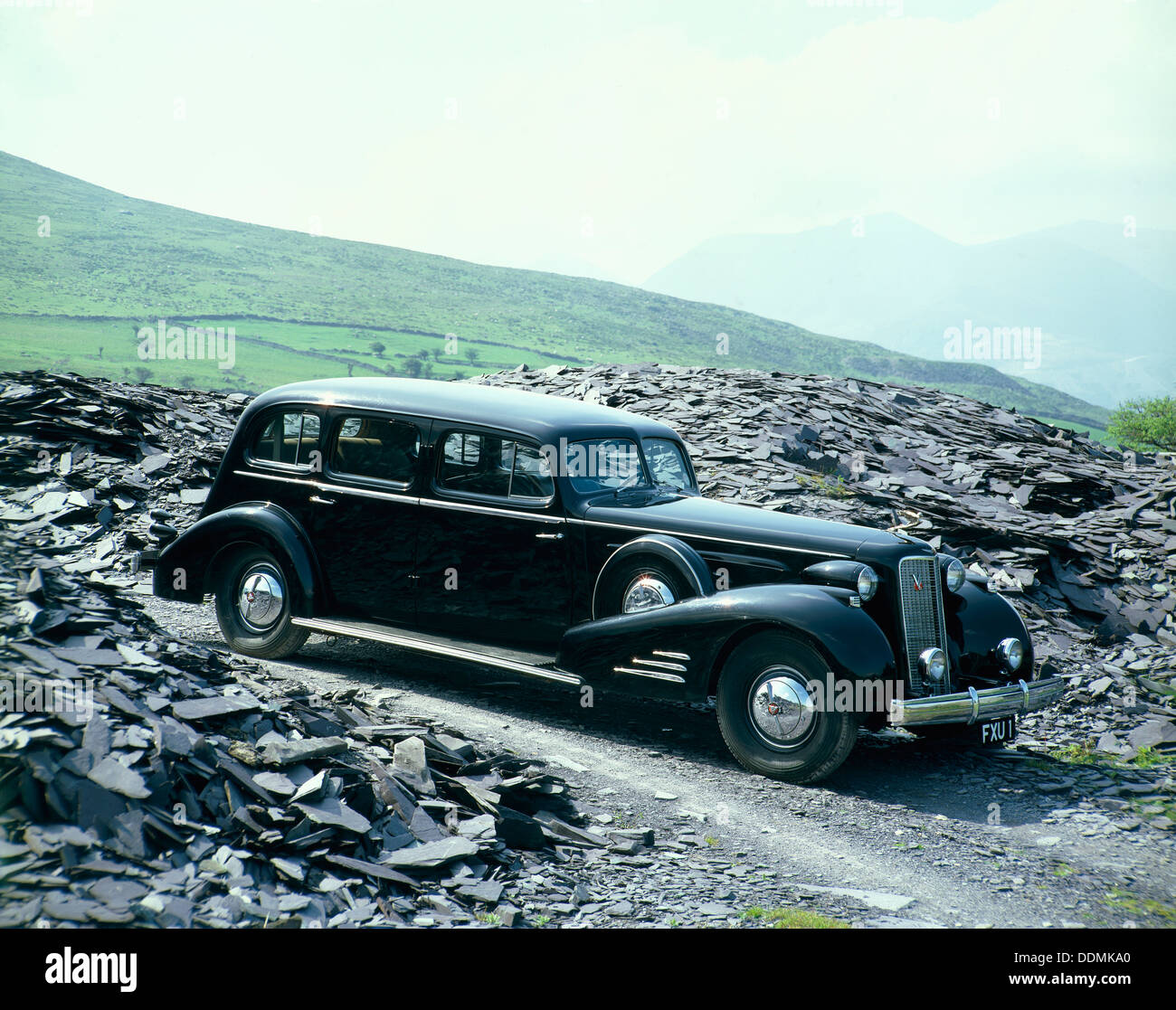 A 1937 Cadillac V16 sedan, photographed among piles of slate. Artist: Unknown Stock Photo