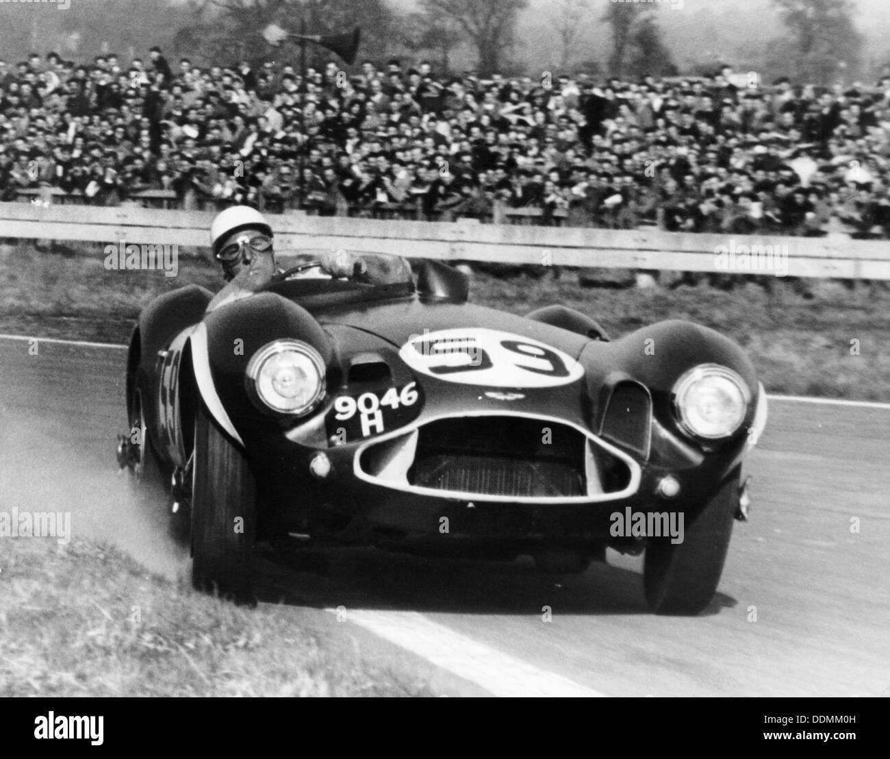 Stirling Moss diving an Aston Martin DB3S, Goodwood, West Sussex, 1956. Artist: Unknown Stock Photo