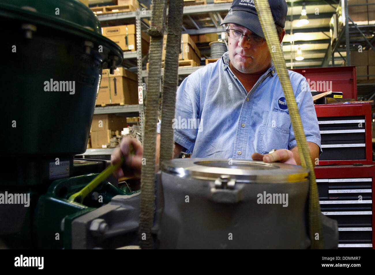 Bartlett, Tenn, USA. 4th Sep, 2013. September 4, 2013 - Experitec, Inc. valve technician Robert Quinn works on rotating a valve in the company's warehouse that is located in the original Brunswick Elementary School's gymnasium. © Mark Weber/The Commercial Appeal/ZUMAPRESS.com/Alamy Live News Stock Photo