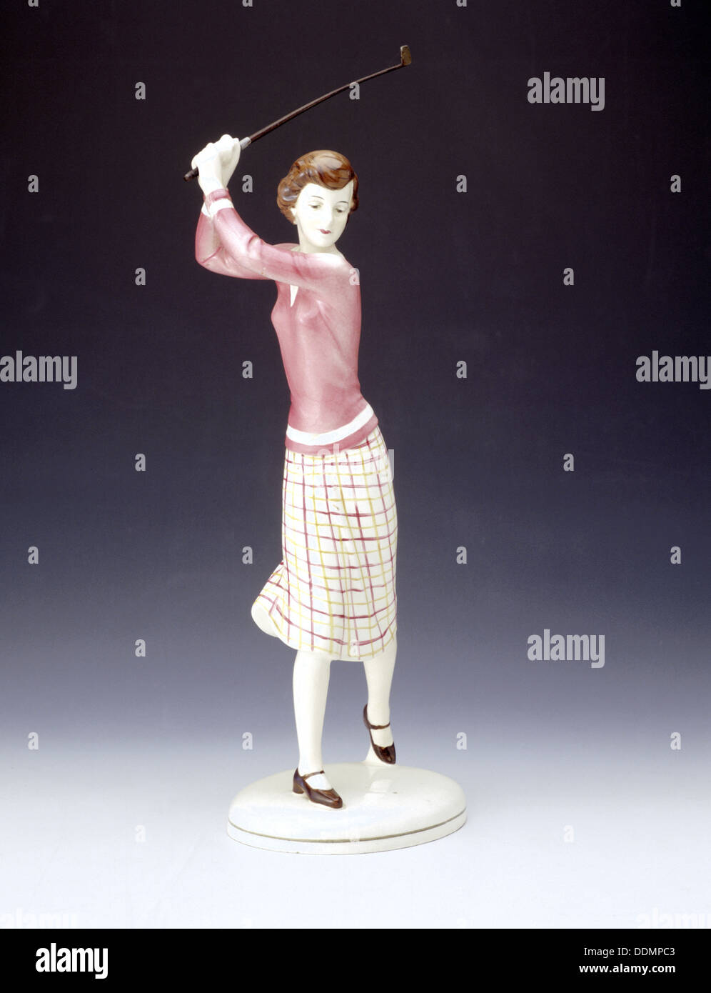 Ceramic figurine of a lady golfer, c1920s. Artist Unknown Stock Photo