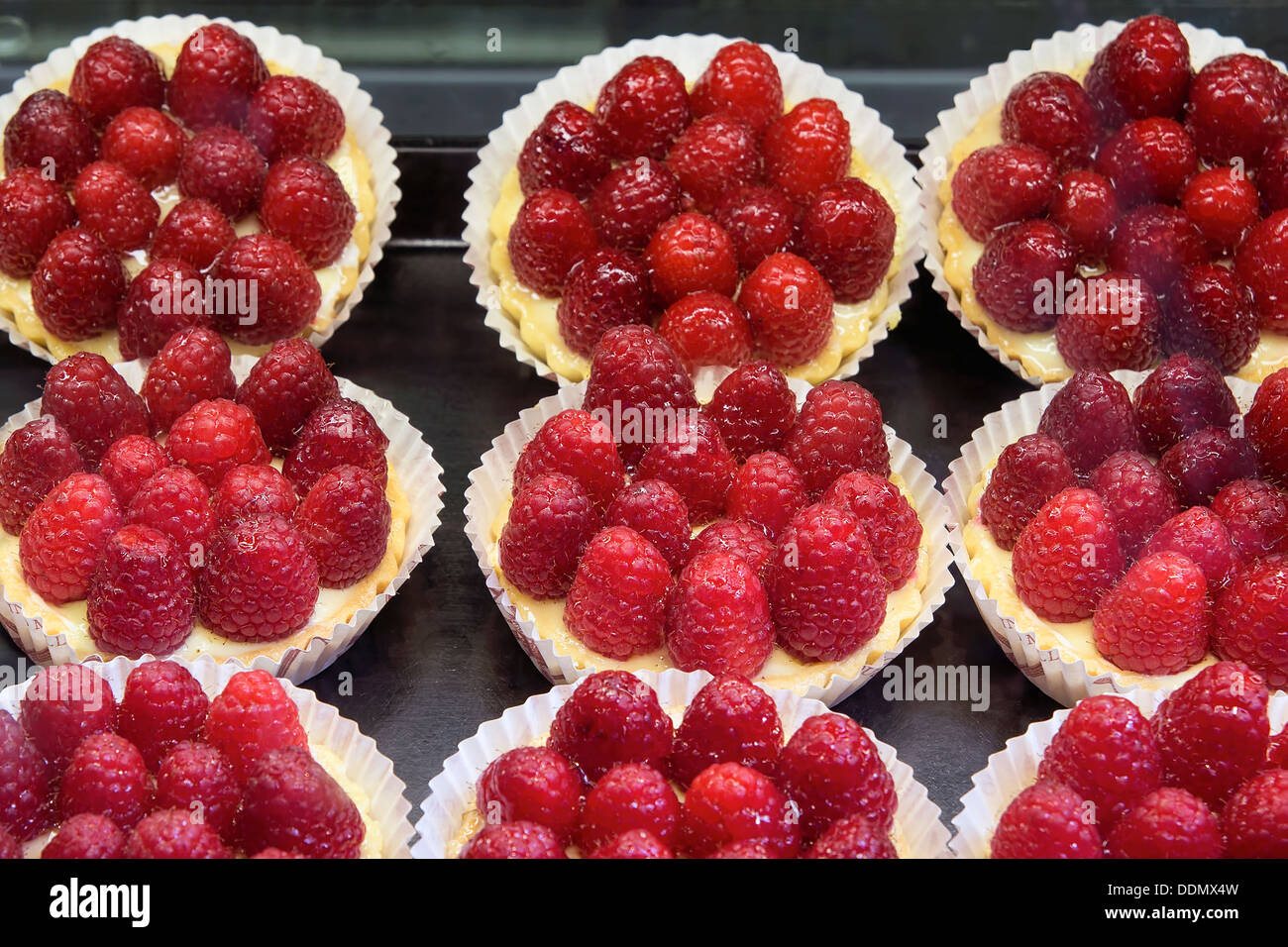 Lemon Curd Fruit Tarts with Raspberries at Bakery Shop Stock Photo