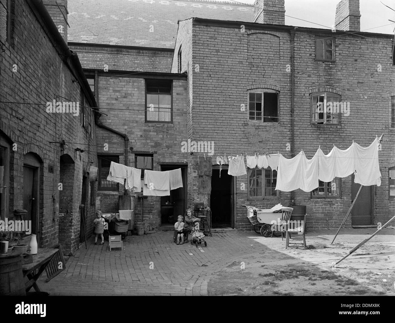 Children in a rundown courtyard, Warwickshire, 1946. Artist Unknown