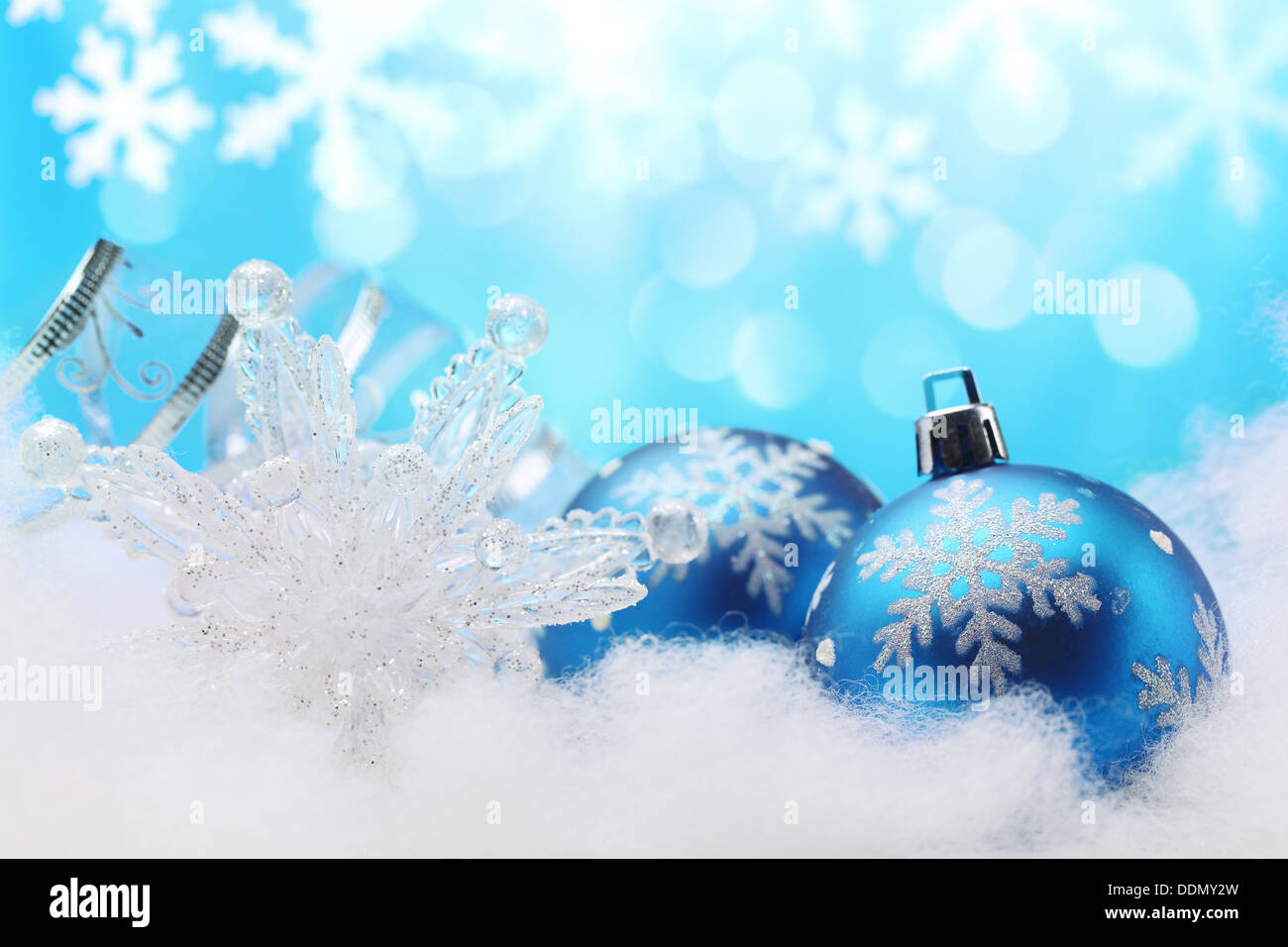 Blue Christmas bauble,snowflake and ribbon in winter setting Stock Photo