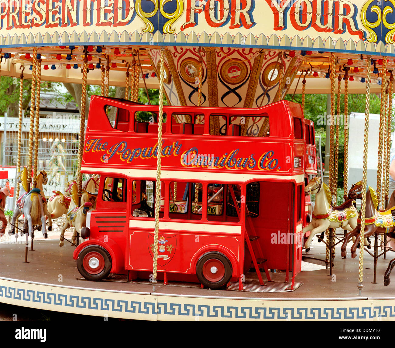 Children's carousel at a funfair in Street, Somerset, c2000.  Artist: M Hesketh-Roberts Stock Photo