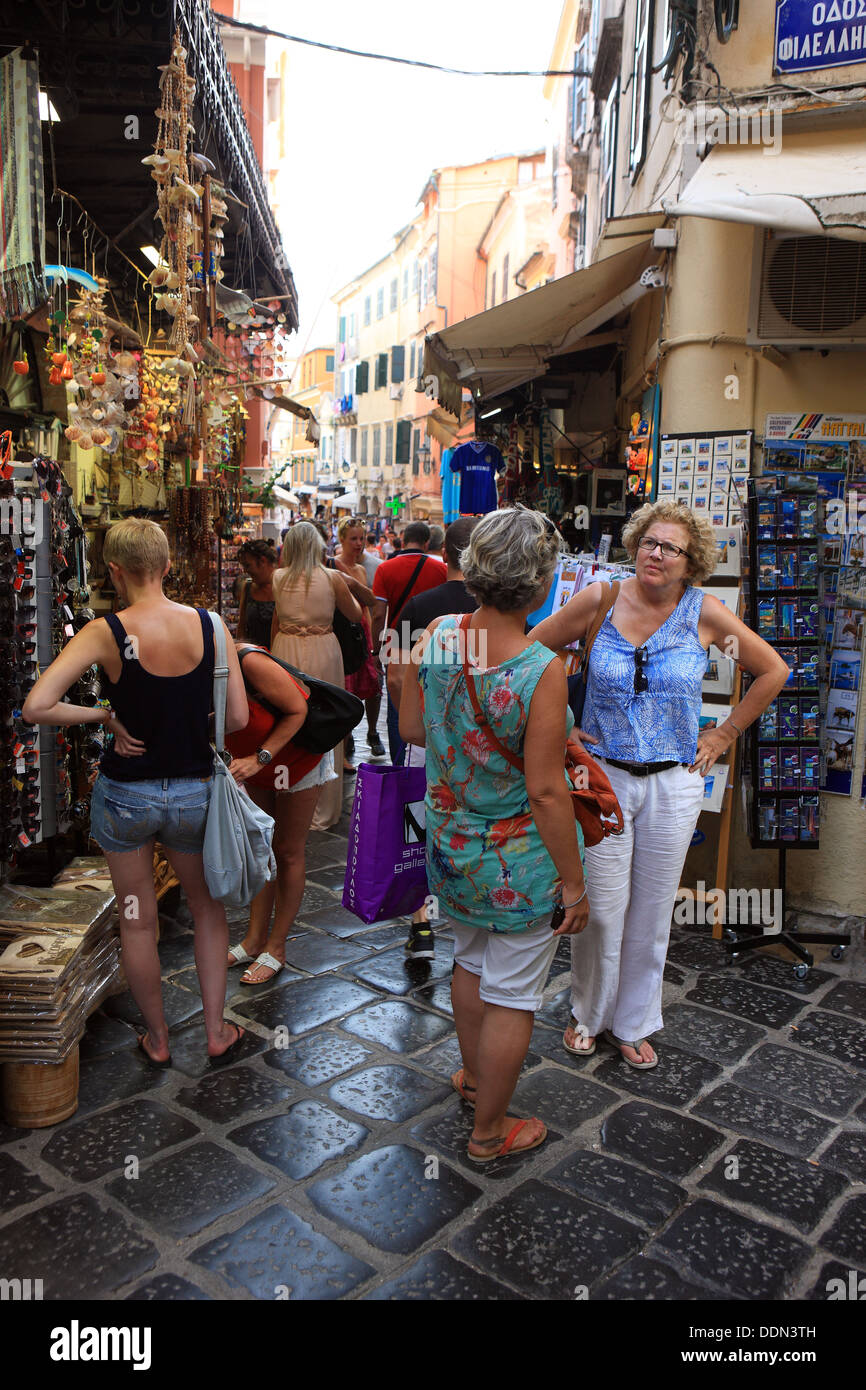 Woman chatting and shopping in the busy narrow tiled streets of Corfu Town Stock Photo