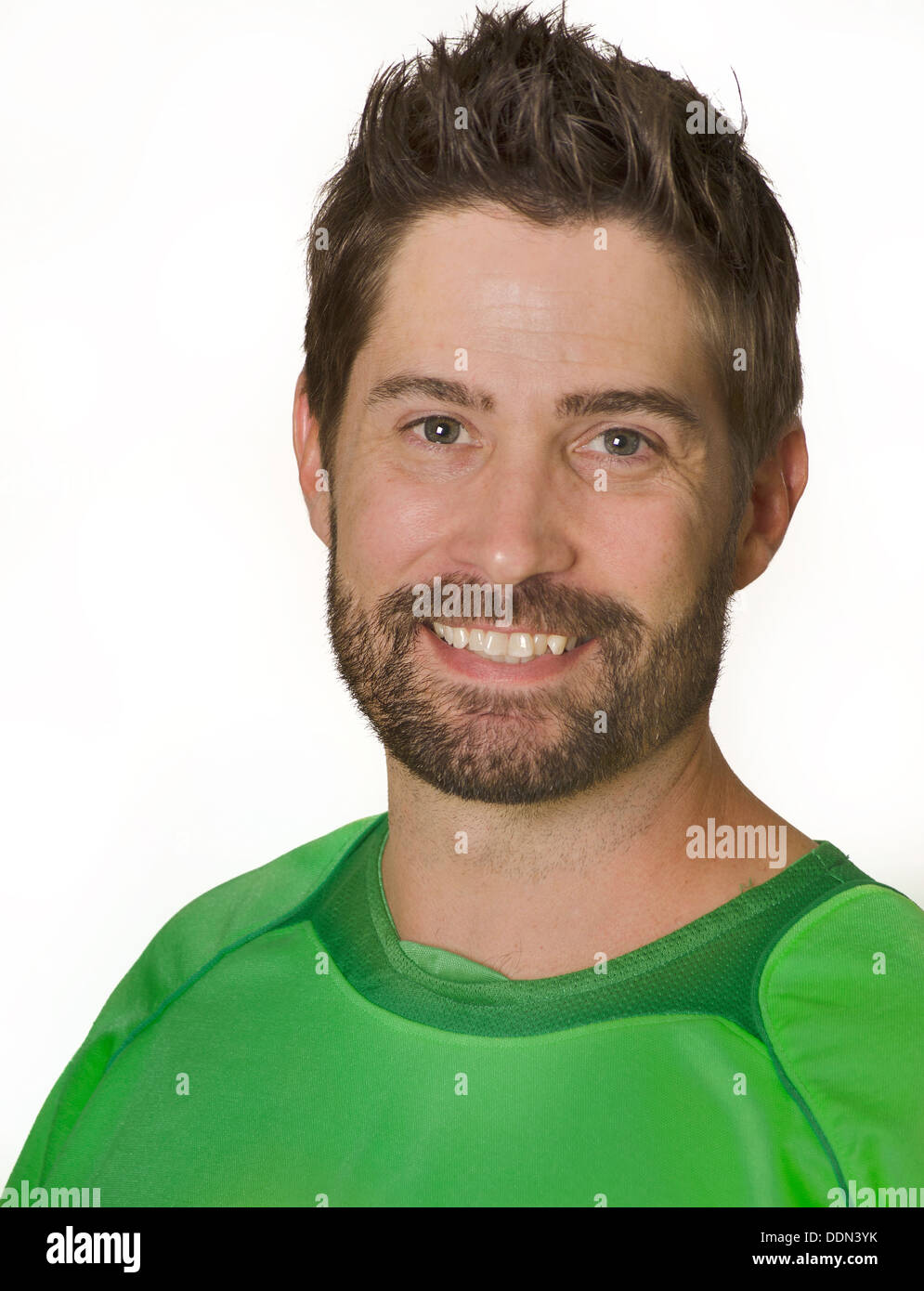 Man smiling wearing green soccer football athletic sport top, coach, sport picture. Stock Photo