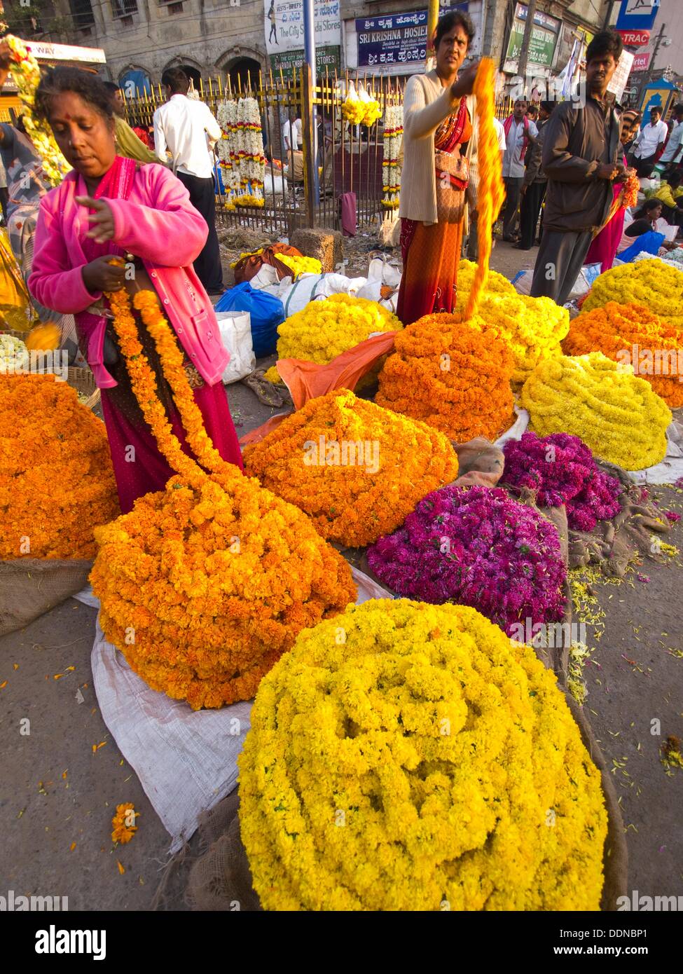 Flower vendors in a flower market outside City Market in Bangalore, Karnataka, India Stock Photo