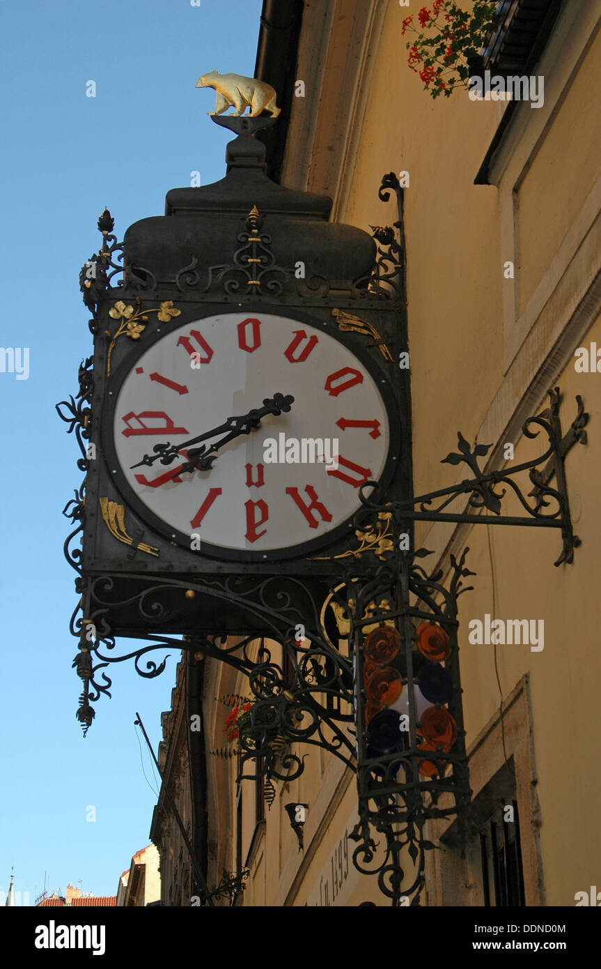 A large retro design clock on the wall at the entrance to U Fleku Brewery and Restaurant which dates back to 1499 in Nove Mesto district Prague Czech republic Stock Photo