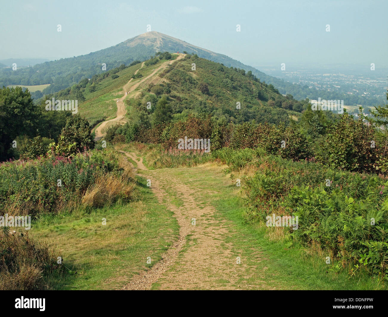 Malvern Hills - the path towards Perserverance Hill from Pinnacle Hill with Worcestershire Beacon rising in the distance. Stock Photo