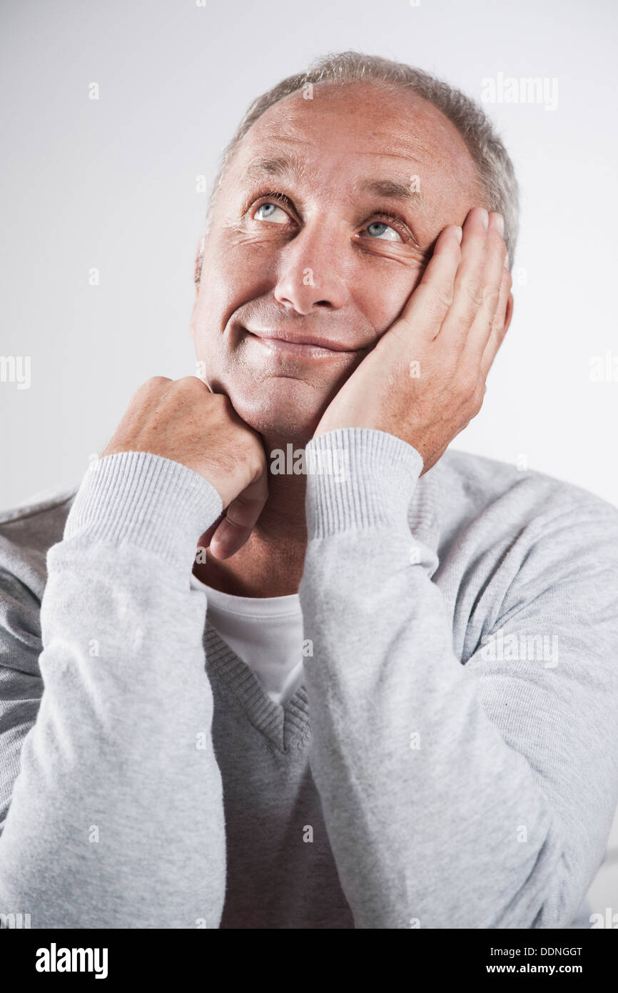 Smiling mature man looking up Stock Photo