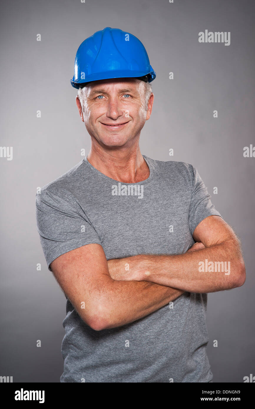 Smiling mature man wearing hard hat Stock Photo