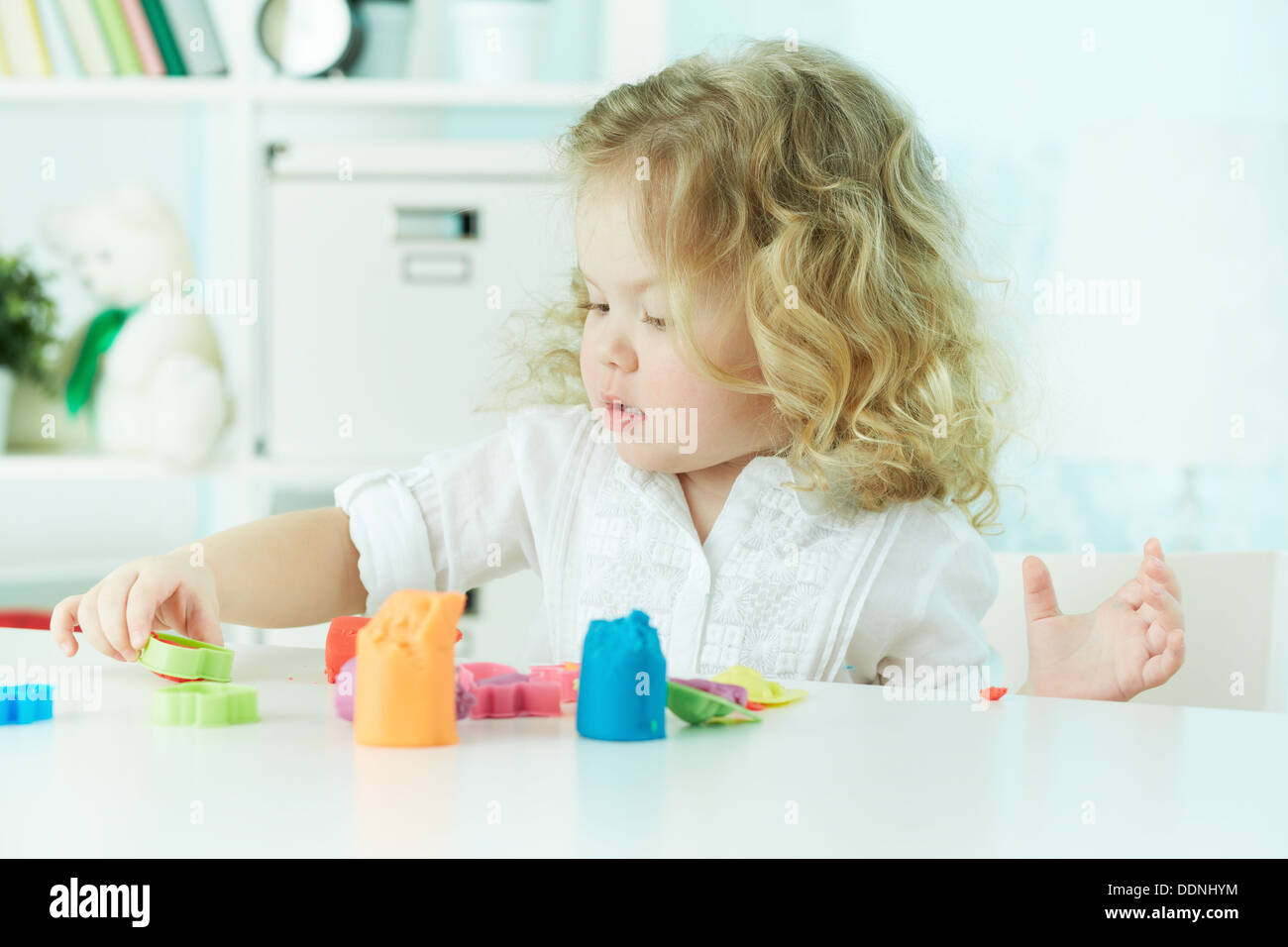 Little girl modeling with clay at kindergarten Stock Photo Alamy