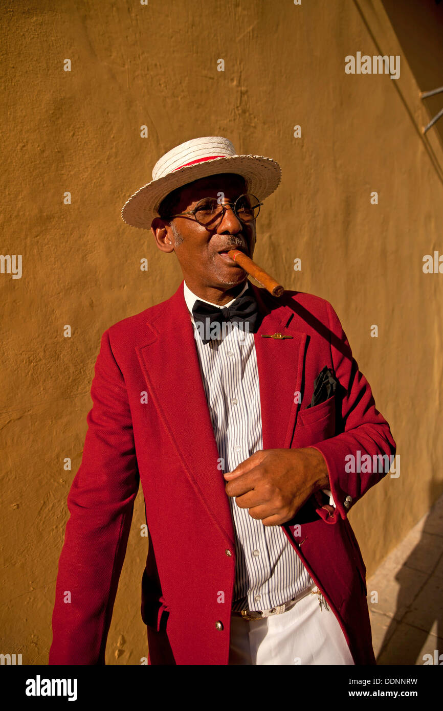 the actor Pedro Pablo Perez with red suit, hat and cigar in Havana, Cuba, Caribbean Stock Photo