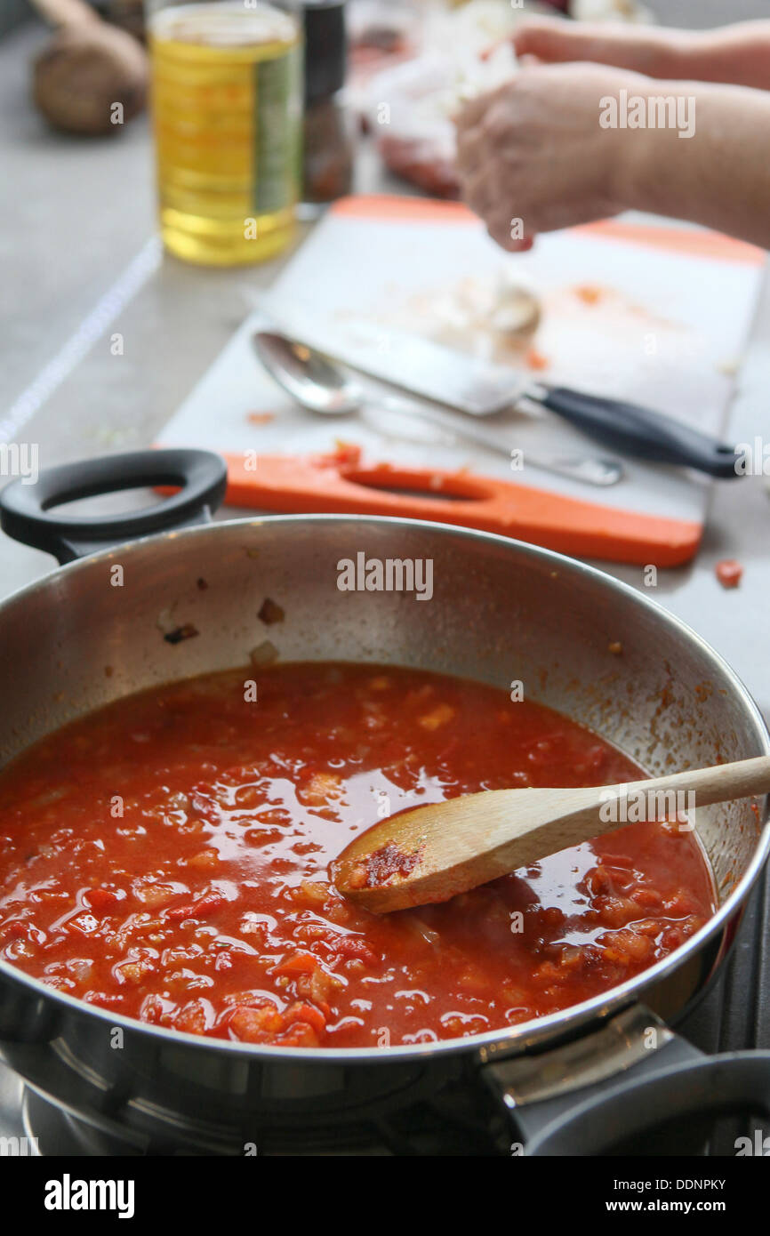 Cooking Moroccan meatballs in tomato sauce. The sauce simmering in a pot Stock Photo