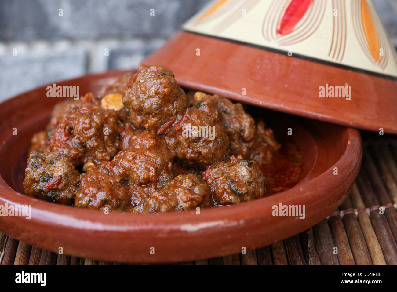 Moroccan meatballs in tomato sauce served in a Tagine (Tajine). Stock Photo